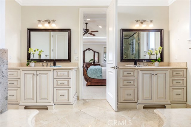 Main bath with dual vanities and marble counters.