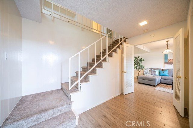 Entry way with stairs that lead up to all five bedrooms.