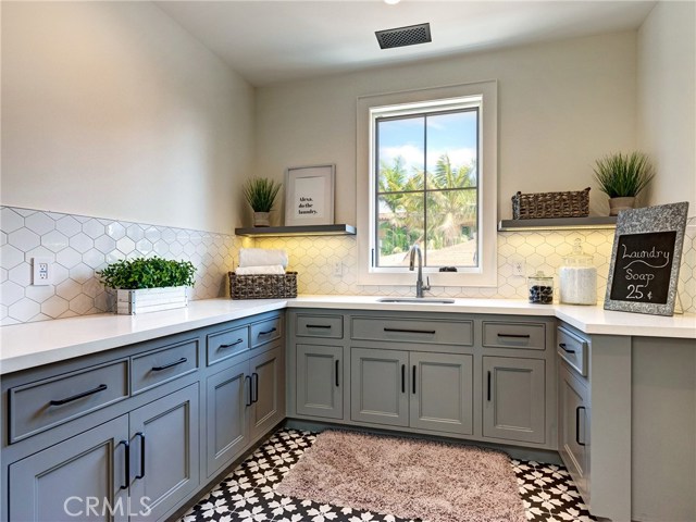 Upstairs/top floor large oversized laundry room with utility sink.
