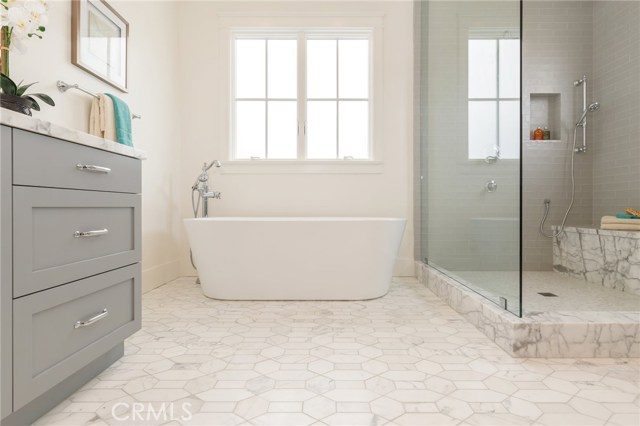 Master bathroom  Carrera details, stepping tub, shower has three faucets, one rain and one hand held