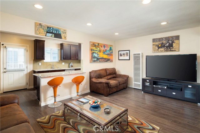 The living room is open to the kitchen with an eat-in counter, perfect for everyday dining and entertaining.