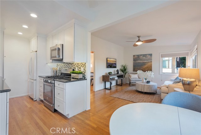 Beautifully remodeled back unit with kitchen, dining area, living room, bedroom, bathroom wood floors, air conditioning and separate entrance.