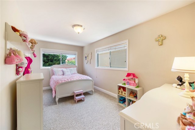 Bedroom with two windows and a walk-in closet