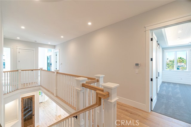 Top of stairs facing bedroom door openings (view of wine cellar below).