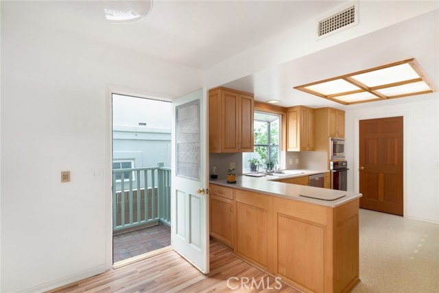 Open door in nook area leads to west side of exterior. Closed door at right is large walk-in pantry.