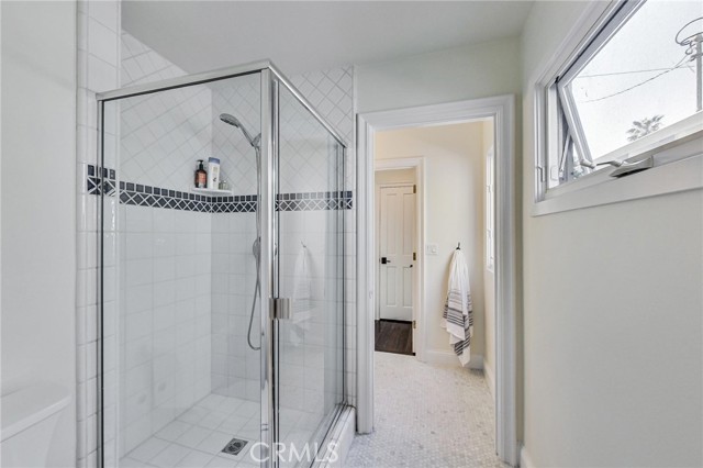 Large shower stall with Century brand enclosure in Jack n Jill bathroom.