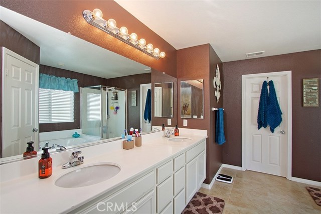 Spacious master bath with dual sinks, beautiful Corian counter tops, garden tub, separate shower.  Walk in closet is just beyond.