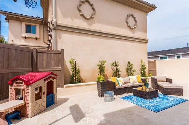 The backyard can double as a living / dining area and play space.
