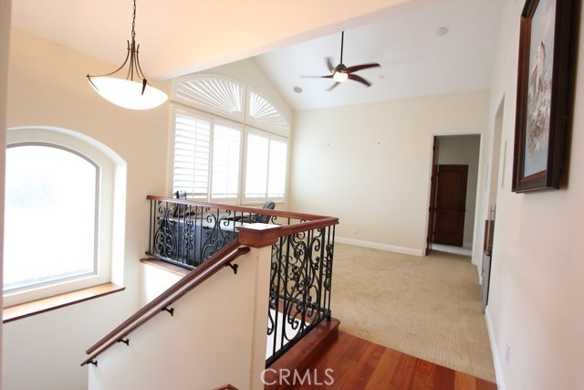 Family room area with plantation shutters to regulate natural light. Built-in audio for home entertainment. Programmable ceiling fan.