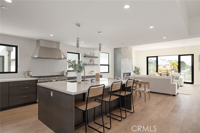 Tastefully appointed modern kitchen opens to living space and extends to the spacious balcony (shown here using reverse of 961 Unit A staging)