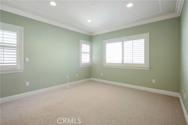 GOOD SIZED BEDROOM WITH CROWN MOLDING, RECESSED LIGHTING , PLANTATION SHUTTERS, NEW CARPET AND PAINT.