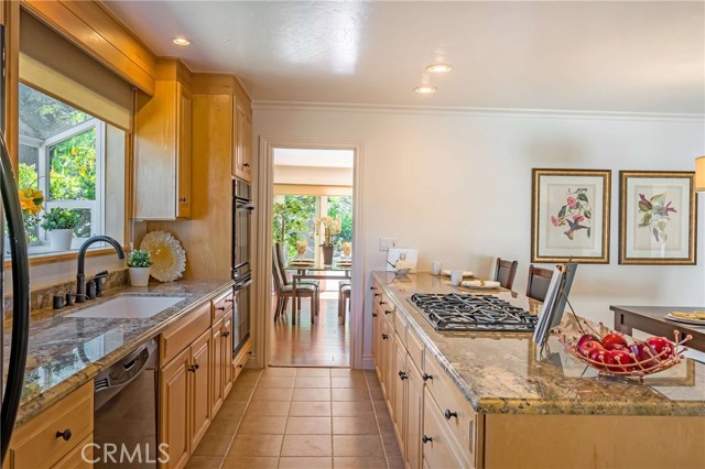 Remodeled kitchen with natural maple cabinets, granite counters