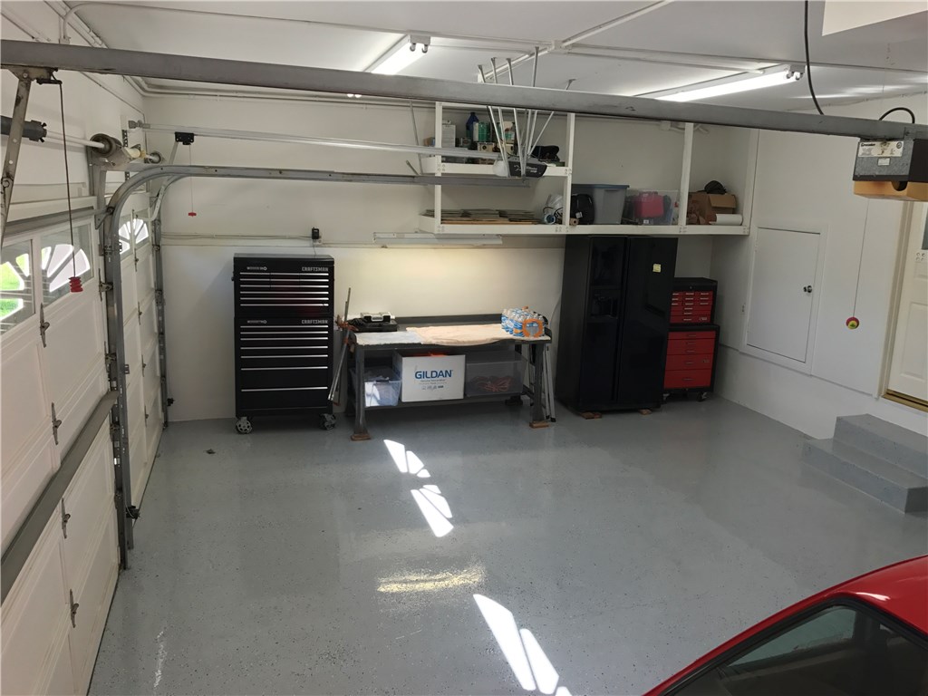 Another vantage point on your light bright three car garage with plenty of storage and new epoxy showroom finish...