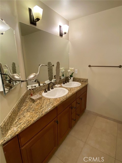 Master Bathroom with Dual Sinks and Granite. Travertine Floors.