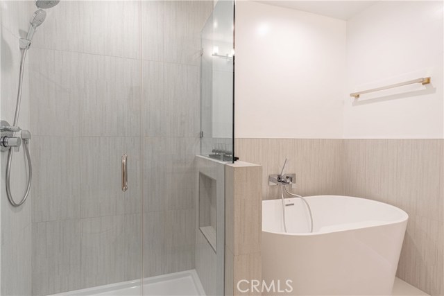 Full tile glass shower with hand-held plus a romantic vessel soaking tub
