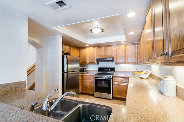 Updated Kitchen has Silestone counter tops, stainless appliances, pantry.