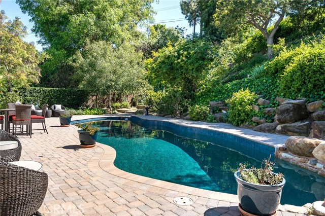 Stunning resort-like backyard with black bottom pool and lush landscape!