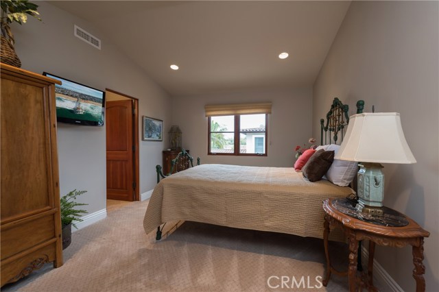 Bedroom #3 with tall vaulted ceilings, recessed lighting, and attached full bath.