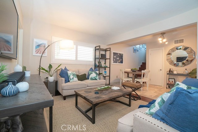 Living room and view of stairway to upper level and bedrooms.