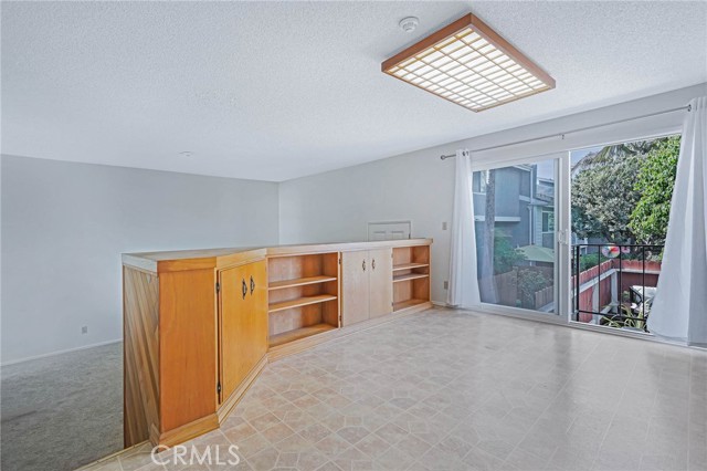 Dining Area with Living Room to the Left, Enclosed Patio Access to the Right, Kitchen is out of the shot and to the Right of the Dining Area.