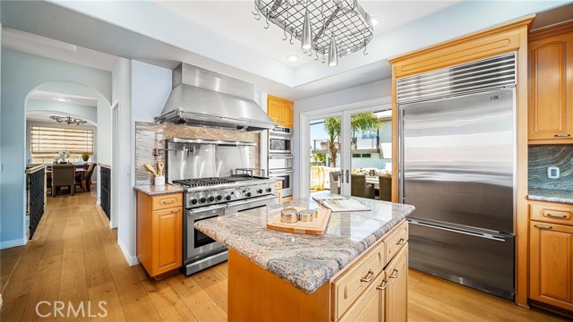 View of kitchen with dining room in the background to the left.  The Sub-Zero refrigerator is large enough to accommodate a house full of guests.