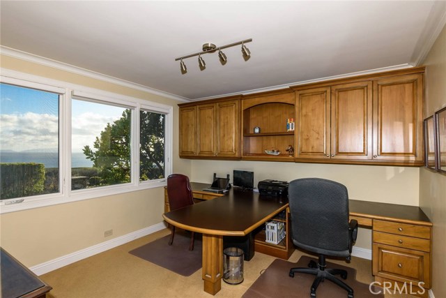 Bedroom used as office with custom built-in cabinetry.