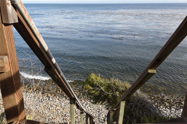 View looking down to the rocky beach below the viewing deck