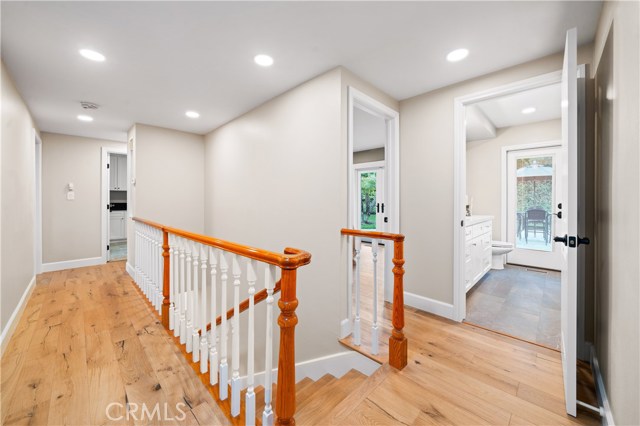 Stairs that lead to garage and downstairs bedrooms and bathroom.