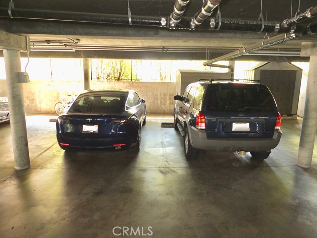 2 full size parking spaces. The space on the left has the electric charging station.