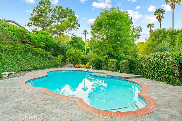 Large private pool backyard with a lush garden.