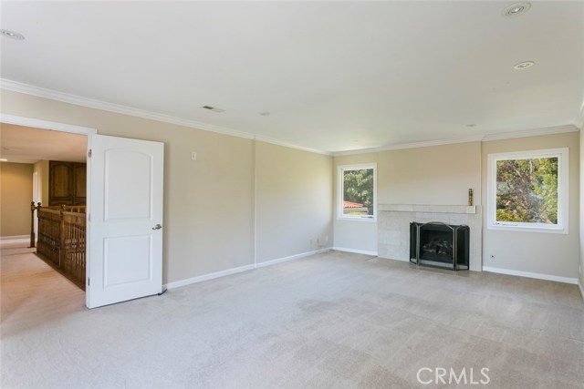 Spacious master with fireplace and balcony with view.