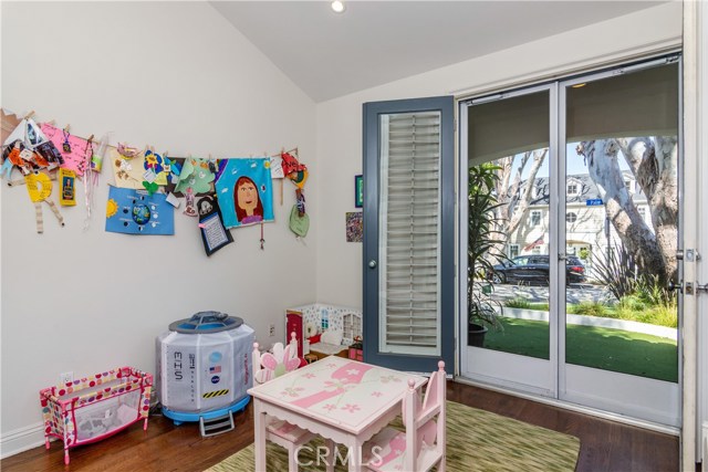 Main Level Bedroom currently used as a Playroom, has outside access to the putting green.