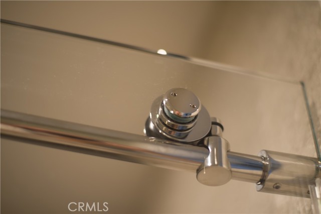 Detail of frameless sliding glass shower door-Master ensuite