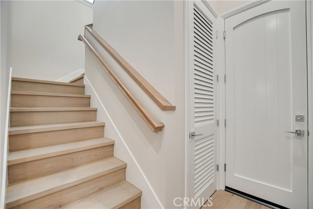 STAIRCASE TO 2ND LEVEL . . . ENTRY TO GARAGE