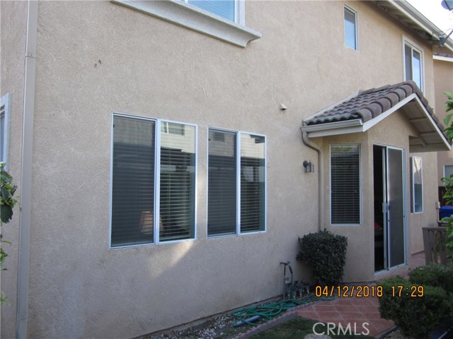 Back of house with sliding glass door to backyard.