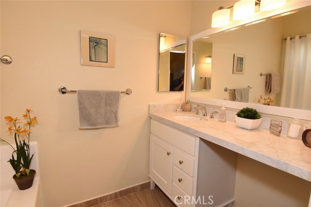 The separate 2nd master bath area has a nice tiled soaking tub and another beautiful new sink & vanity with Carrara marble tops, new tile floors, sink and faucet.