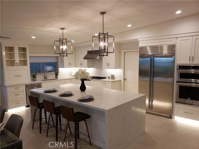 Beautiful custom kitchen, Sub Zero refrigerator, floor and under cabinet lighting, marble back splash