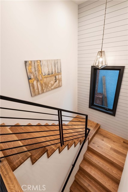 Note the custom tongue in groove wood treatment in the stairway.