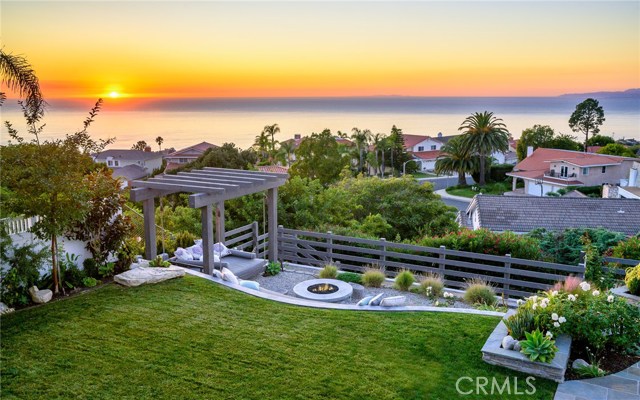 View of grassy area and sunset from balcony
