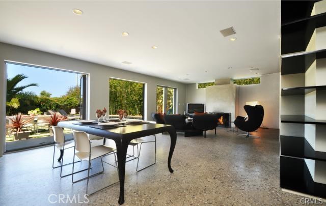 A grand view of the great room with all three sets of french doors and a bit of the library as well...