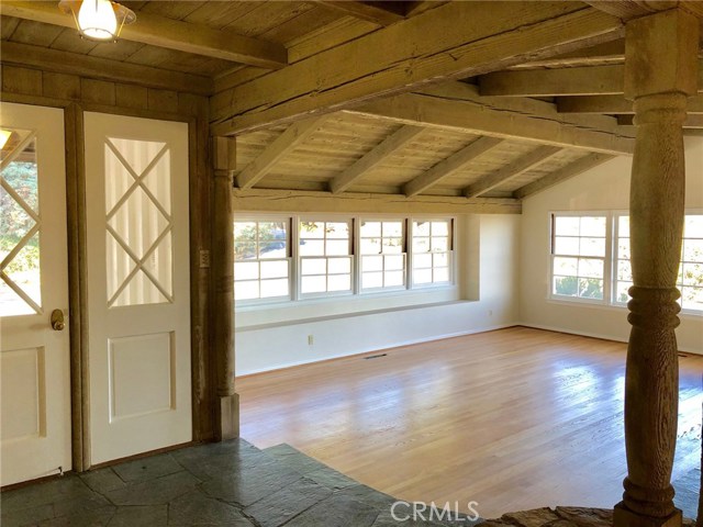 Front Door and Slate Entry with Two Steps Down to the Living Room. Floors Refinished and Room Repainted.