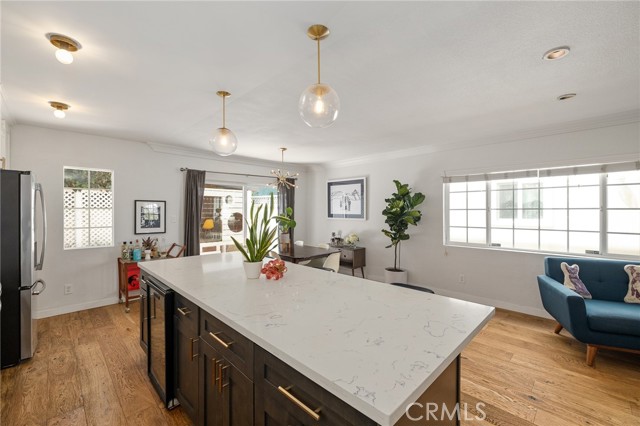 9 foot island with Quart countertops and wine fridge opening to dining room