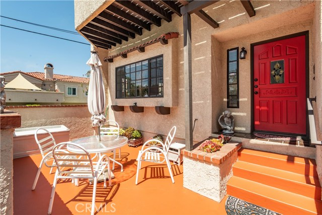 Lively colored private, open patio for lounging and entertaining outside of front entrance.