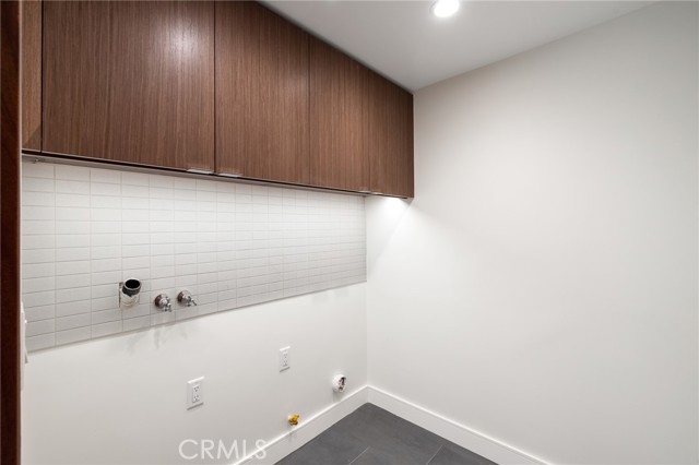 Separate laundry room with fine custom cabinetry