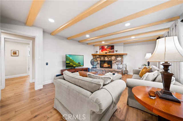 Family room with a custom wood burning fireplace made with PV stone.