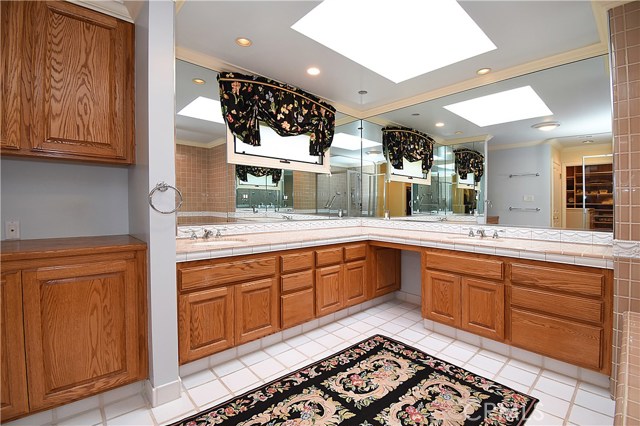 Master bath features 2 separate sink areas, tons of storage, sky light.