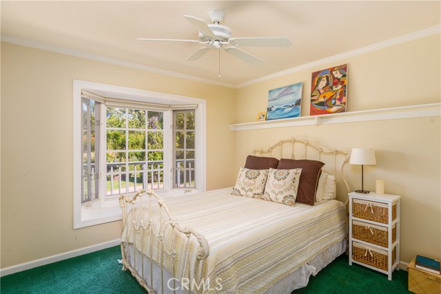 Bedroom with bay window overlooking the backyard.