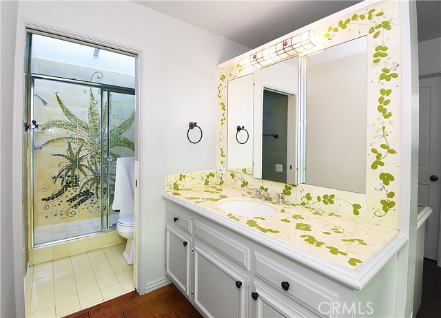 Handprinted tile in the his and hers master bath. One side has the shower and toilet