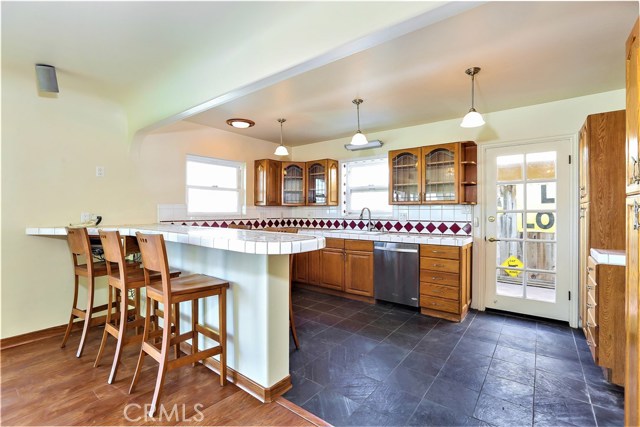 The Kitchen has an open floor plan with a breakfast bar, surrounding work counter spaces and abundant storage cabinets.