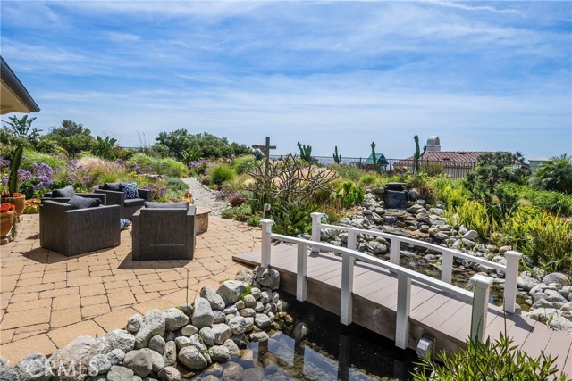 The bridge to the guest house, fire pit, and beautiful garden.